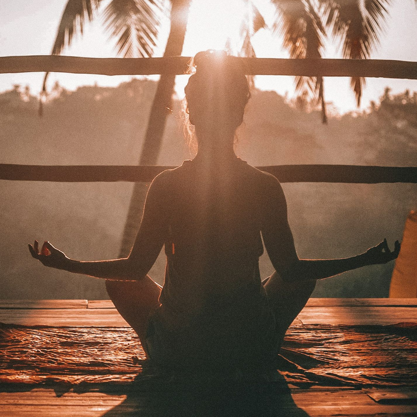woman doing yoga meditation on brown parquet flooring